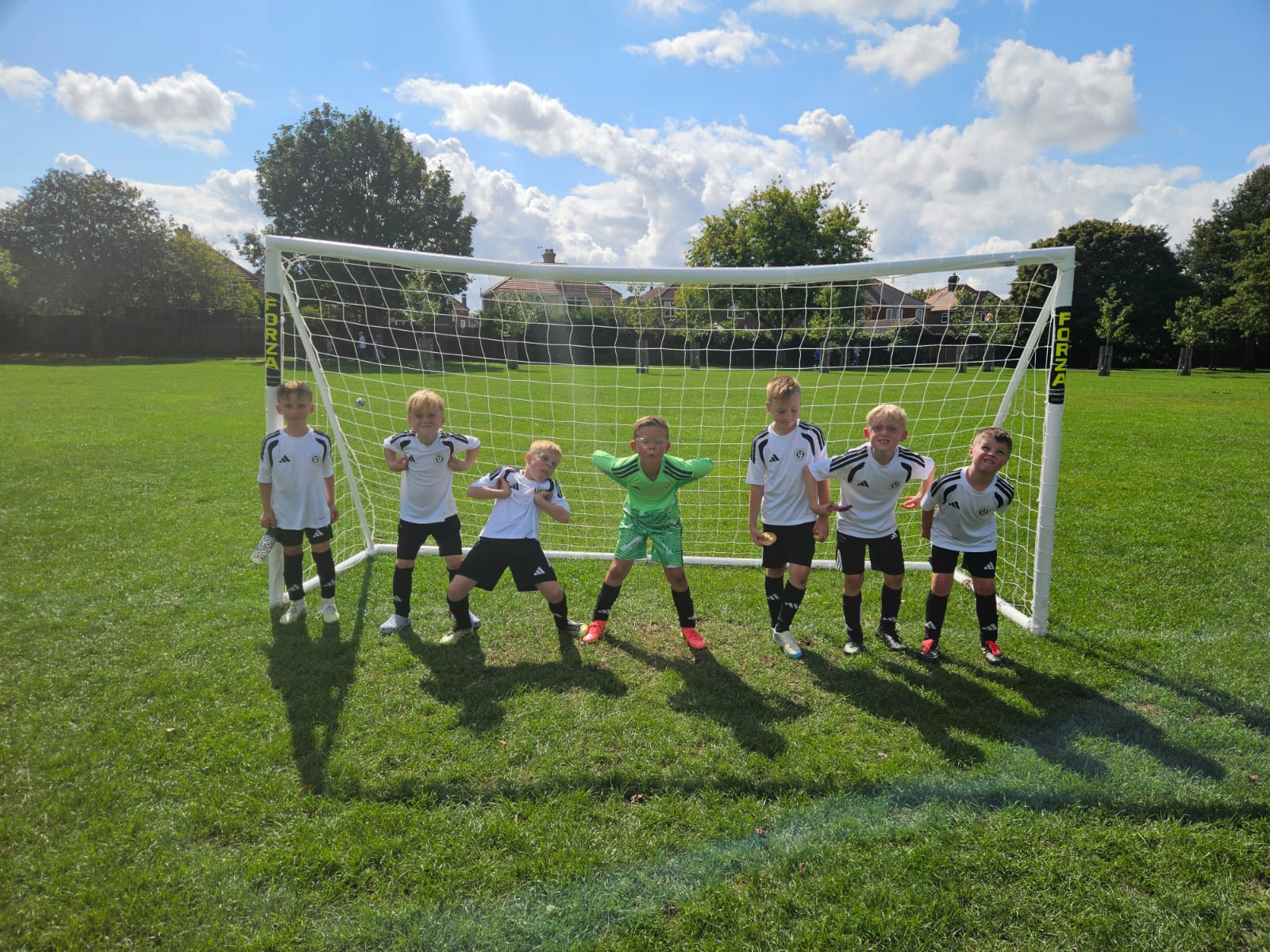 Grimsby United U8 Cosmos squad lined up in the goalmouth after their friendly