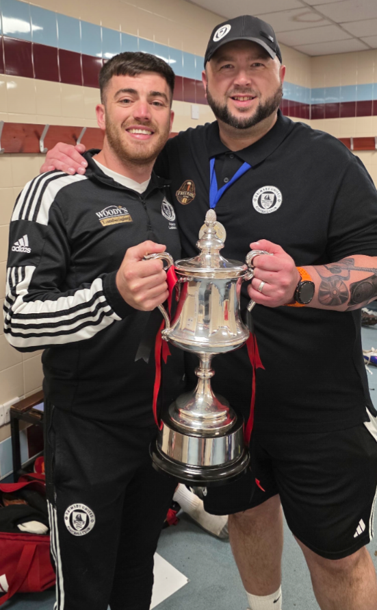 Players and staff with the cup