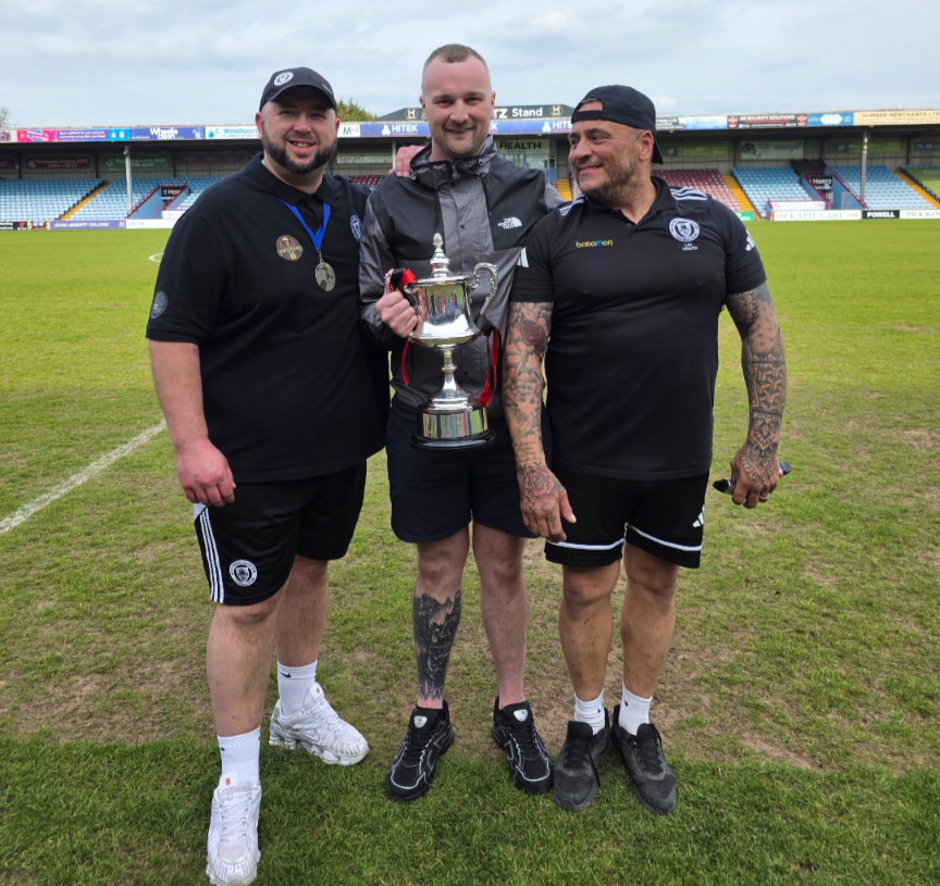 Grimsby United players lifting the supplementary cup