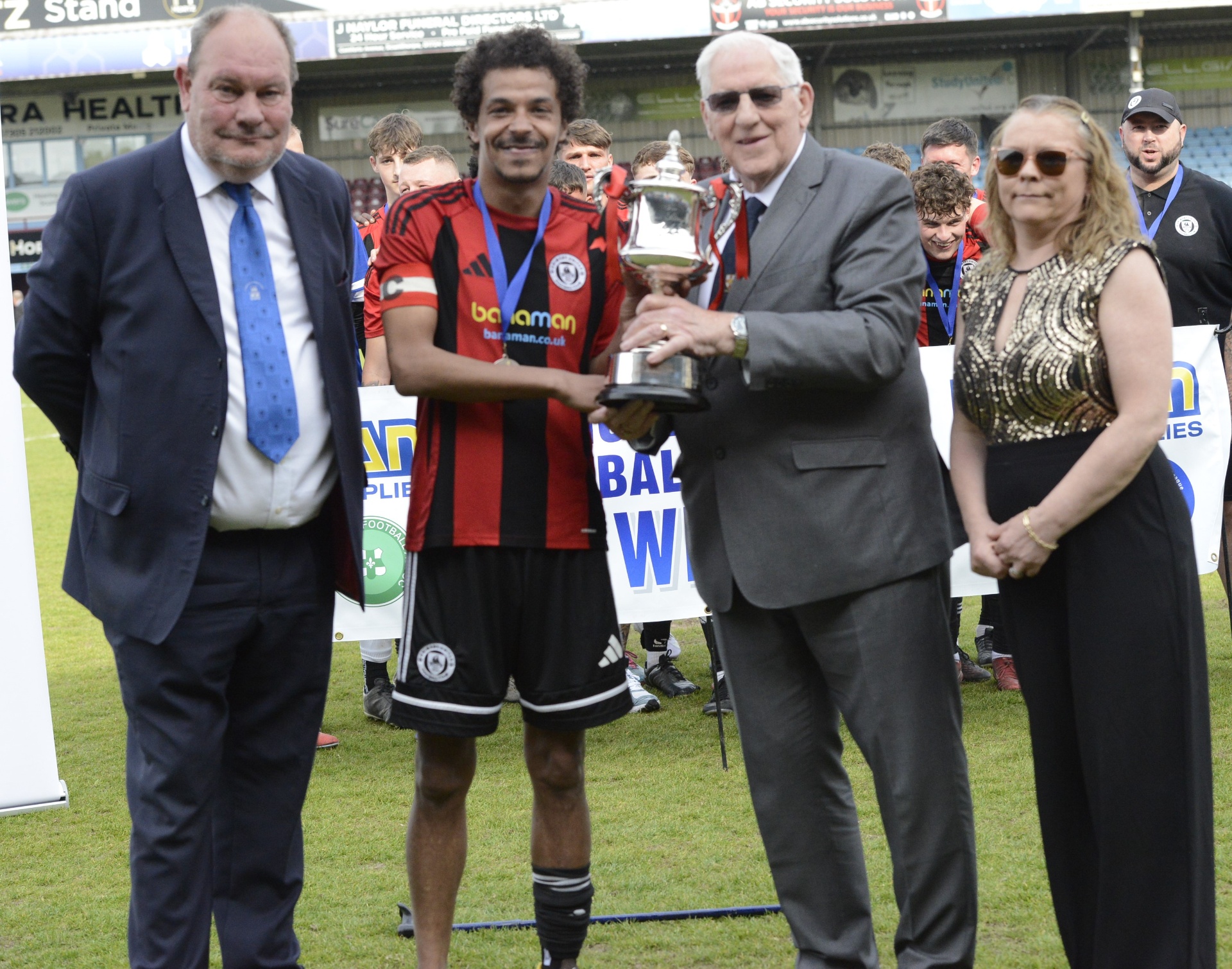 Captain Dave Deane lifting the Supplementary Cup trophy