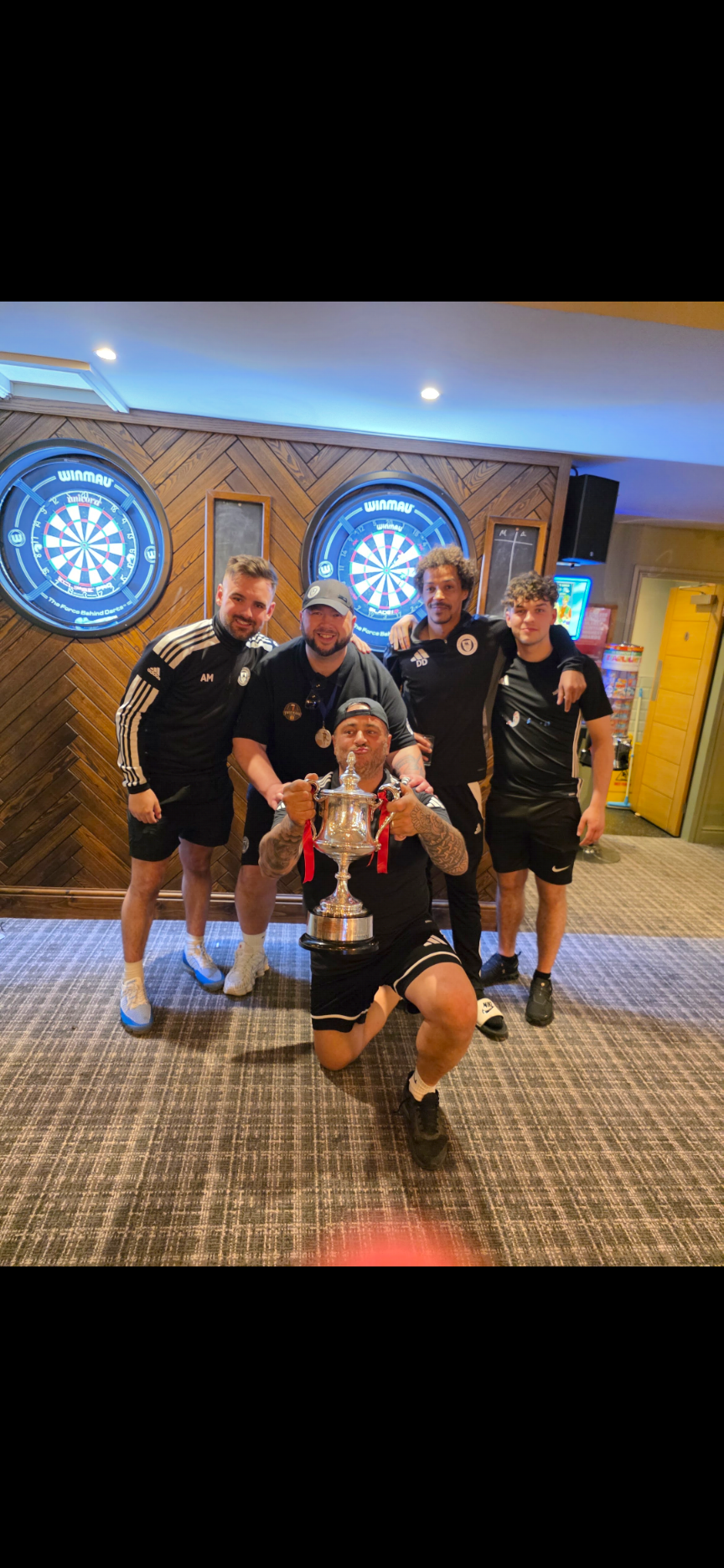 Grimsby United squad and staff celebrating the 2025/26 cup win